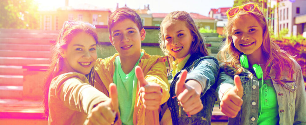 happy students or friends showing thumbs up happy students or friends showing thumbs up